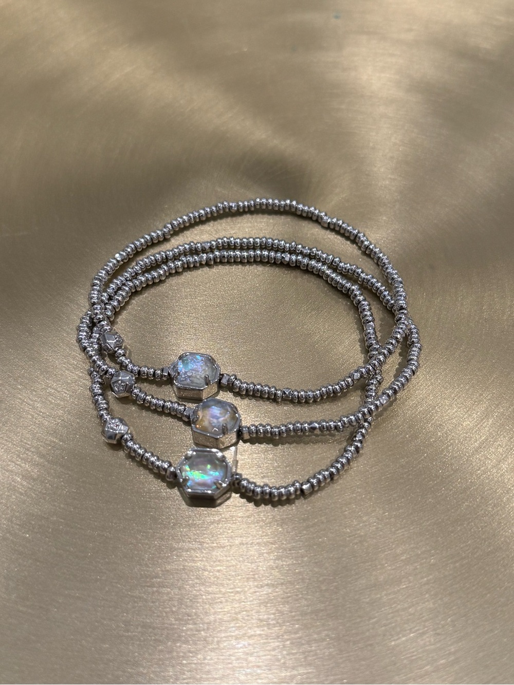 Set of 3 Kendra Scott stretch bracelets. Silver-tone beaded bands. Hexagon stone